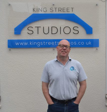 King Street Studios CIC photo of man standing infront of King Street sign