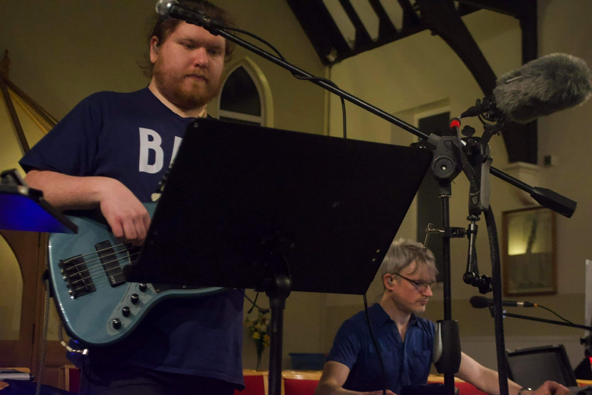 Bassist and band in rehearsal